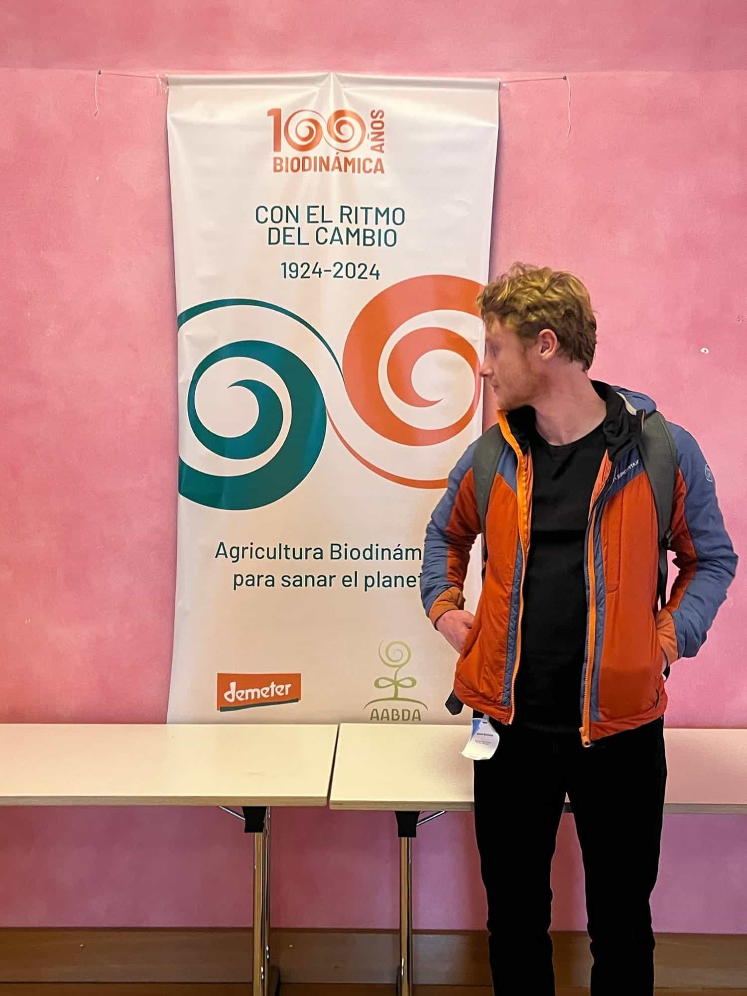 Young man with a backpack at Biodynamic Trainee event, promoting sustainable biodynamic farming practices.
